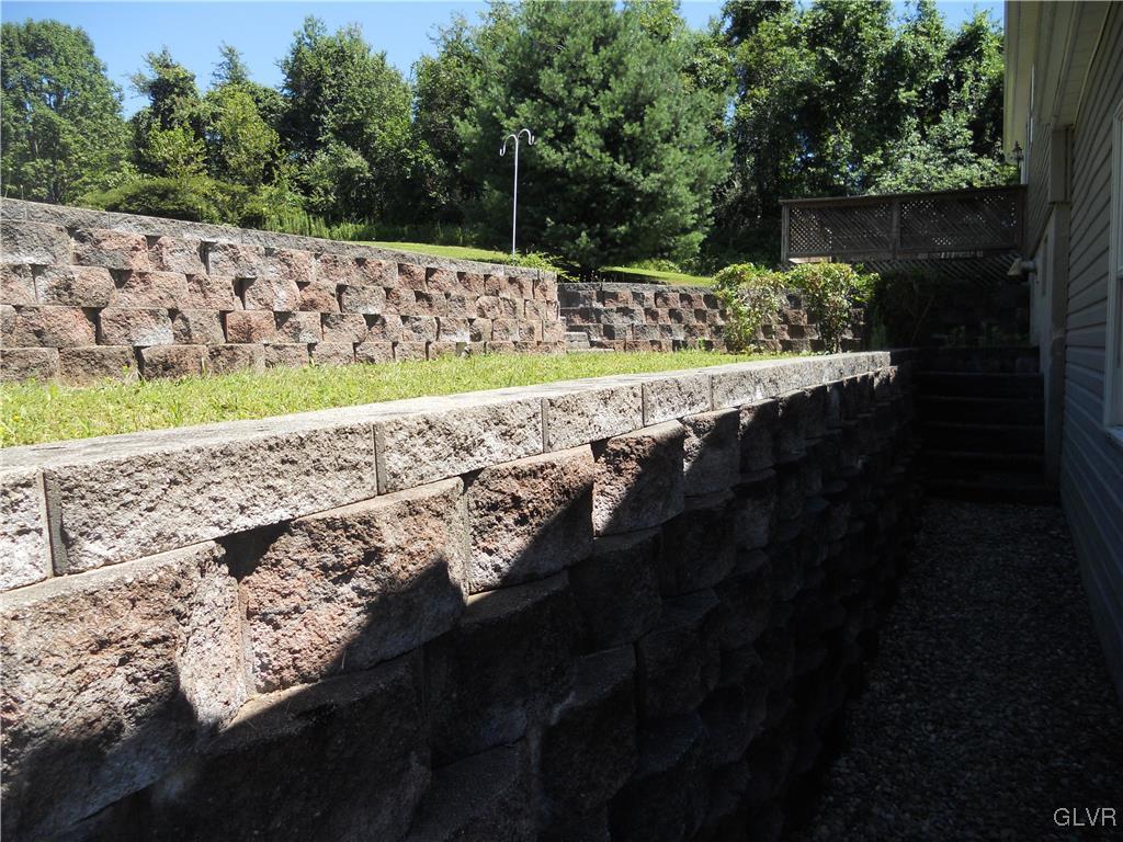 568 Allegheny Road Mount Bethel, PA 18343 - Photo 25 of 36 Landscape stone ease up into the back yard
