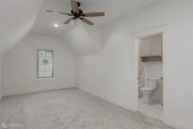 an empty room with a bathroom and a toilet