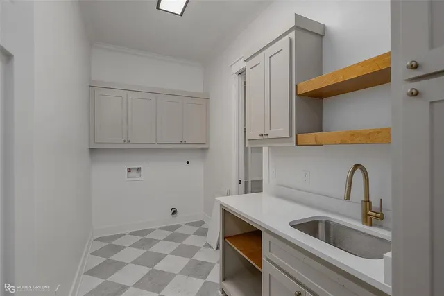 a kitchen with sink cabinets and utility