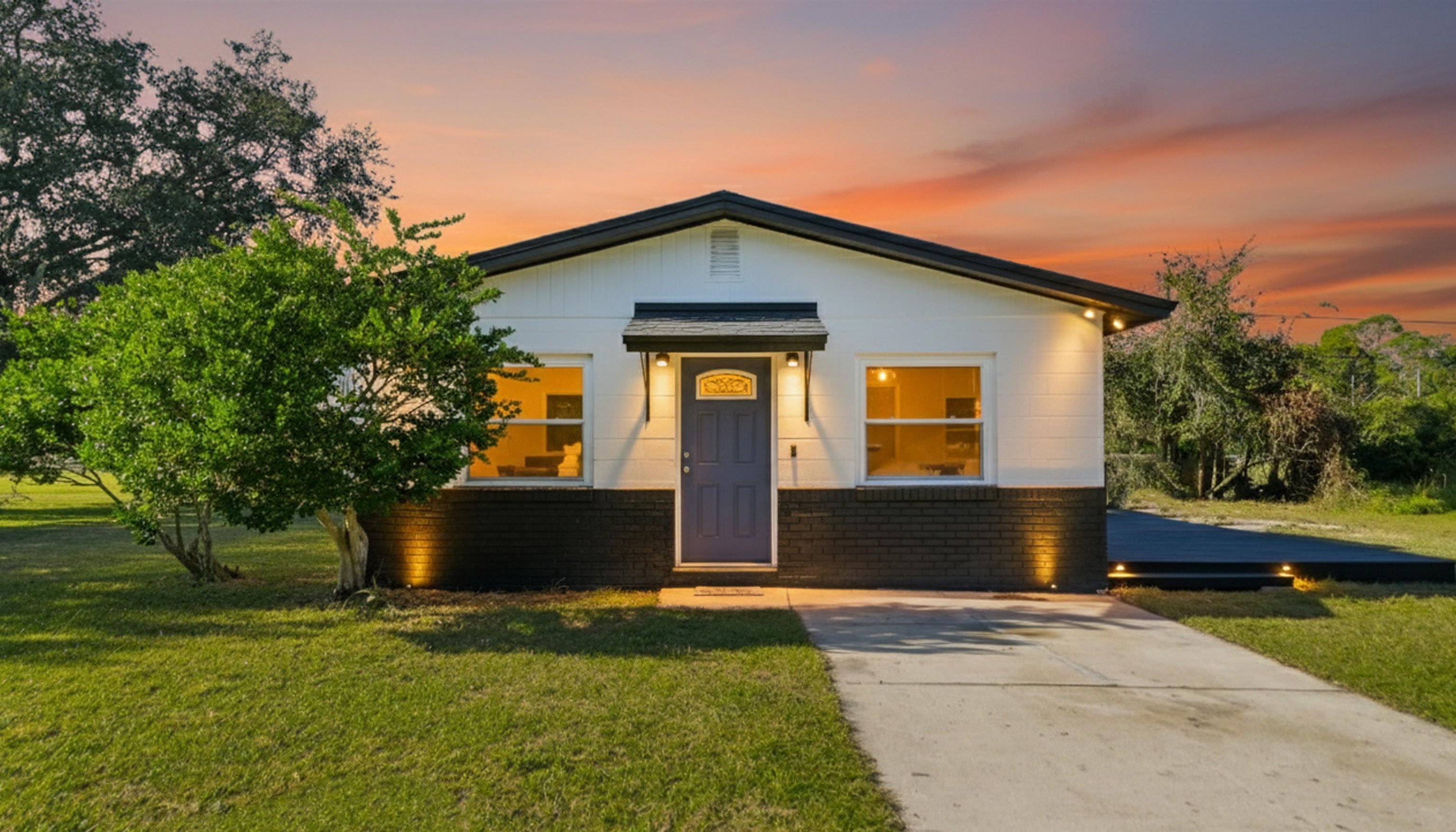 a front view of a house with garden