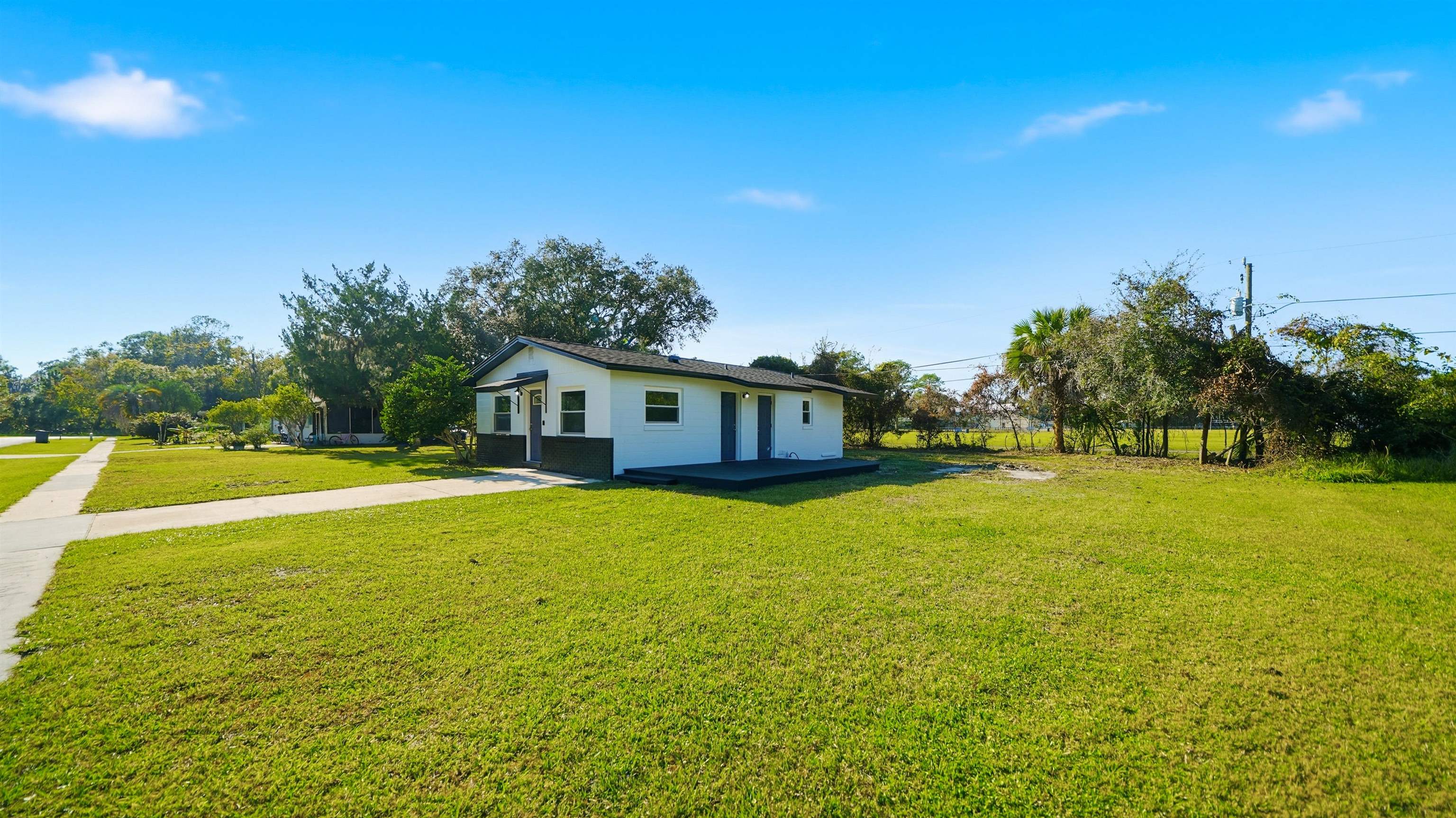 811 Hymon Circle Bunnell, FL 32110 - Photo 15 of 32 Back of property with a yard and stucco siding