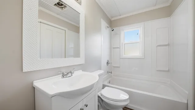 a bathroom with a sink toilet a vanity and bathtub
