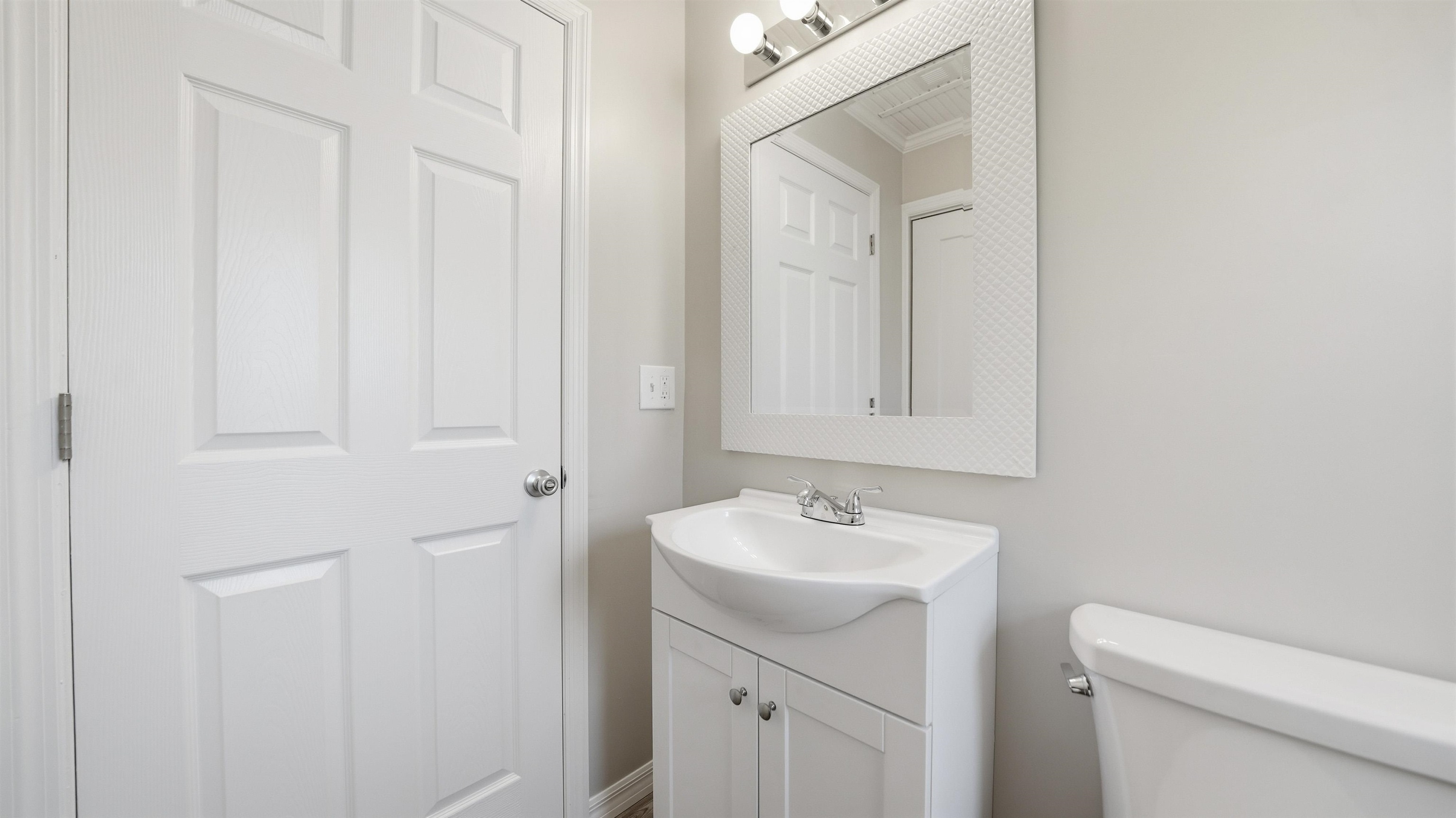 811 Hymon Circle Bunnell, FL 32110 - Photo 17 of 32 a bathroom with a sink a toilet and a mirror