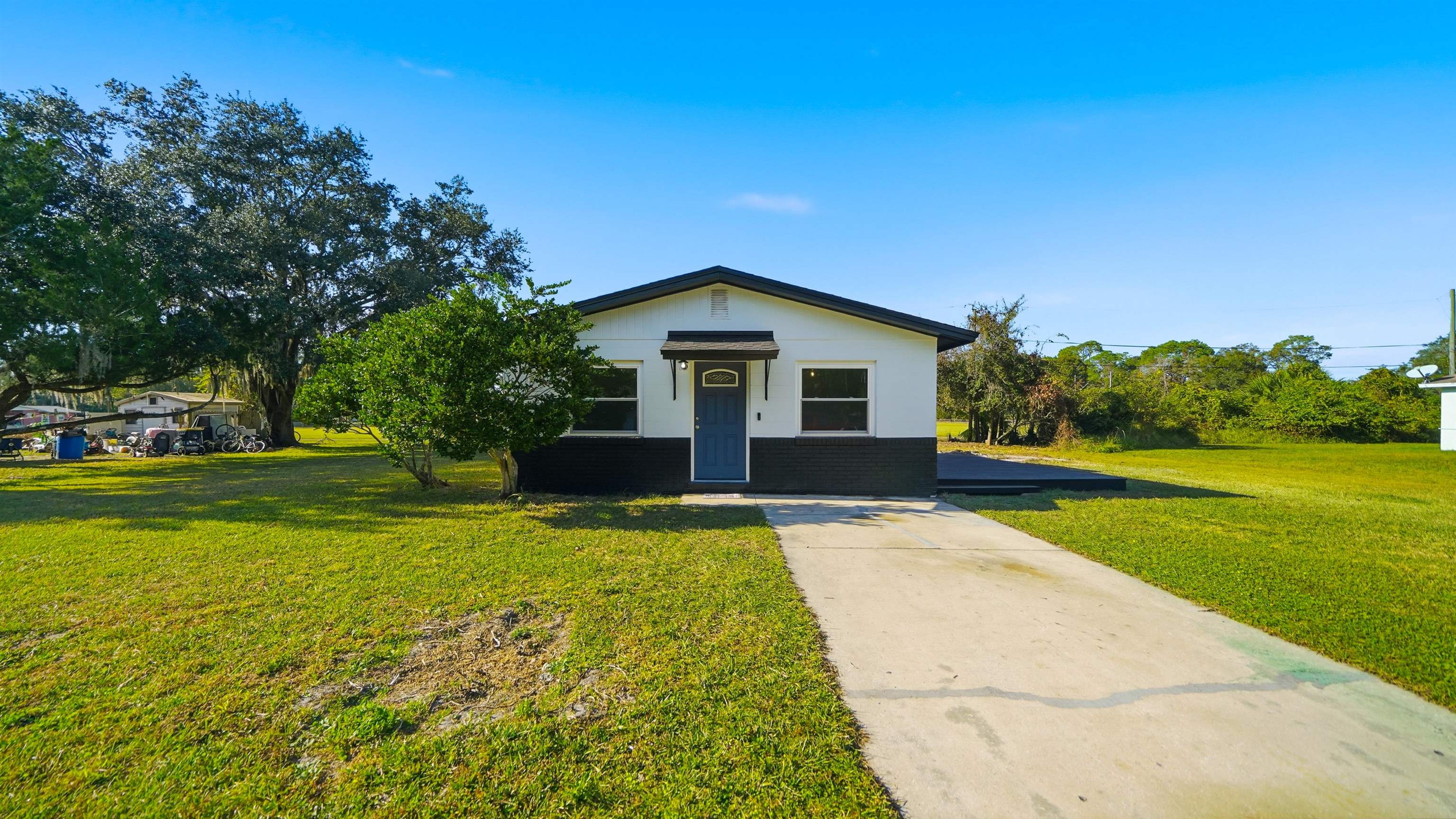 811 Hymon Circle Bunnell, FL 32110 - Photo 28 of 32 View of front of home with a front yard and brick siding