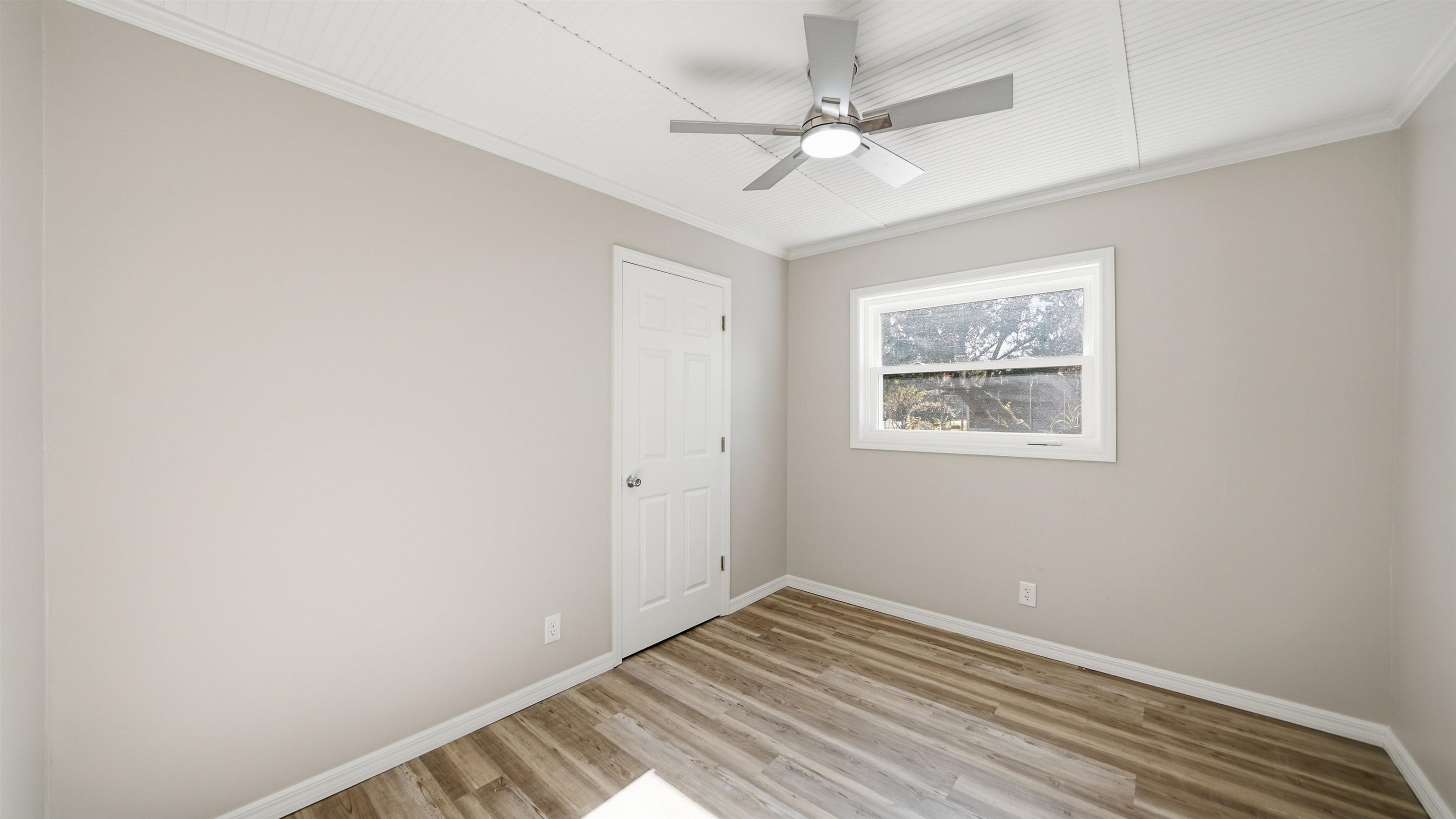 811 Hymon Circle Bunnell, FL 32110 - Photo 9 of 32 Unfurnished room featuring ornamental molding, light wood finished floors, and a ceiling fan