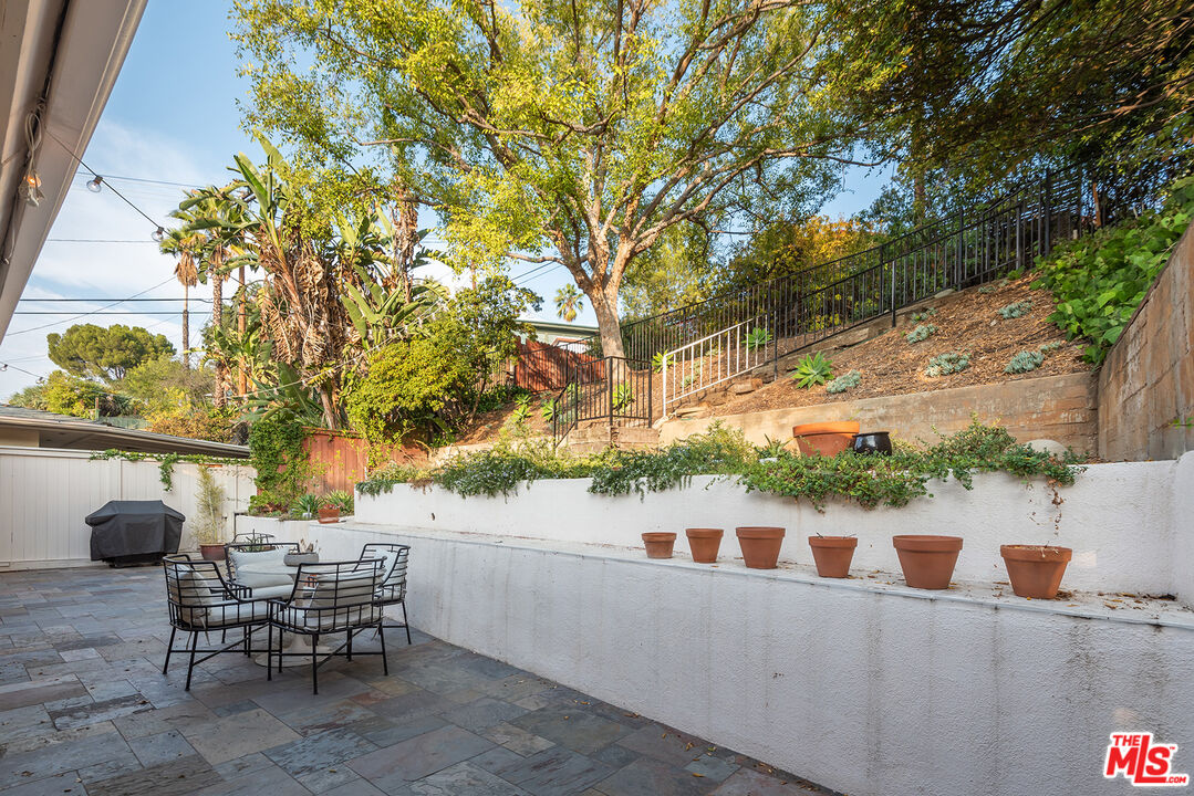 356 Cherry Drive Pasadena, CA 91105 - Photo 19 of 23 a roof deck with table and chairs and potted plants
