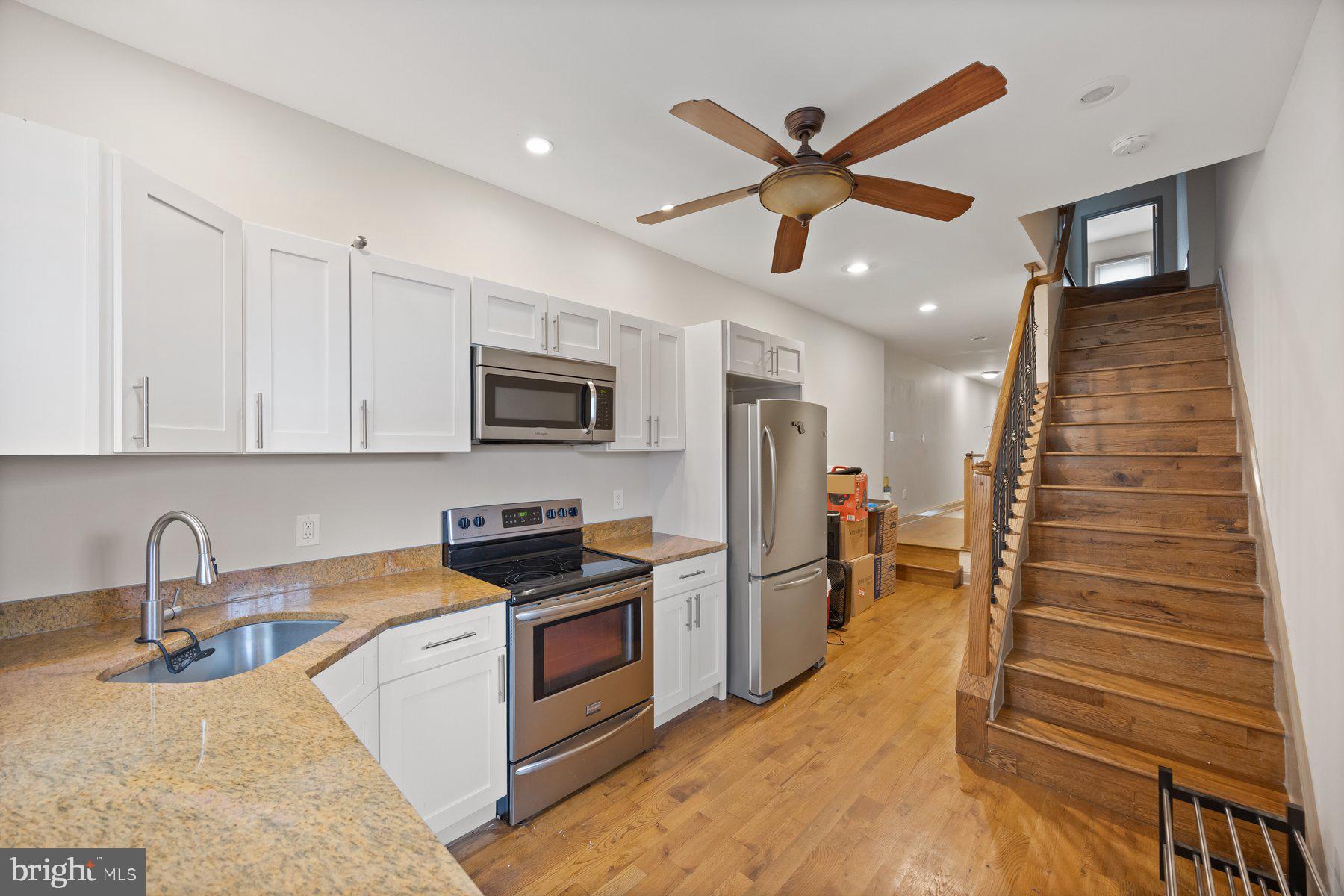 2209 Mullikin Street Baltimore, MD 21231 - Photo 11 of 32 a kitchen with stainless steel appliances granite countertop a refrigerator a stove and a sink