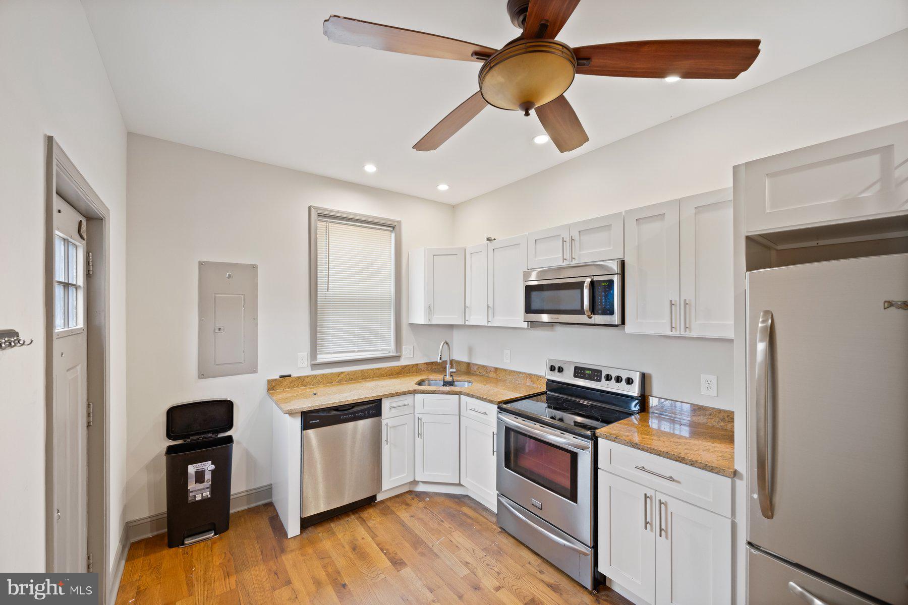 2209 Mullikin Street Baltimore, MD 21231 - Photo 12 of 32 a kitchen with stainless steel appliances granite countertop a refrigerator a stove and a sink