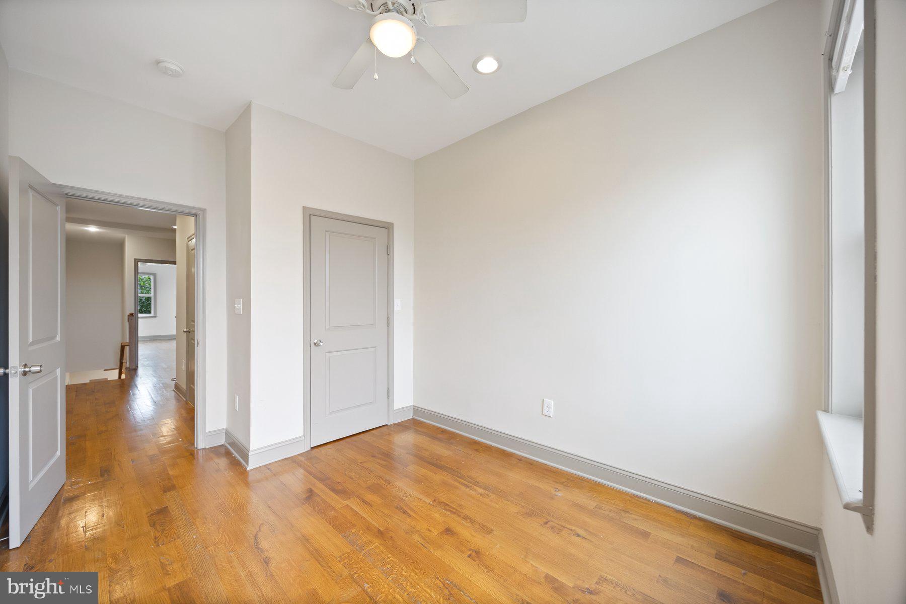 2209 Mullikin Street Baltimore, MD 21231 - Photo 19 of 32 a view of a livingroom with wooden floor and a bathroom