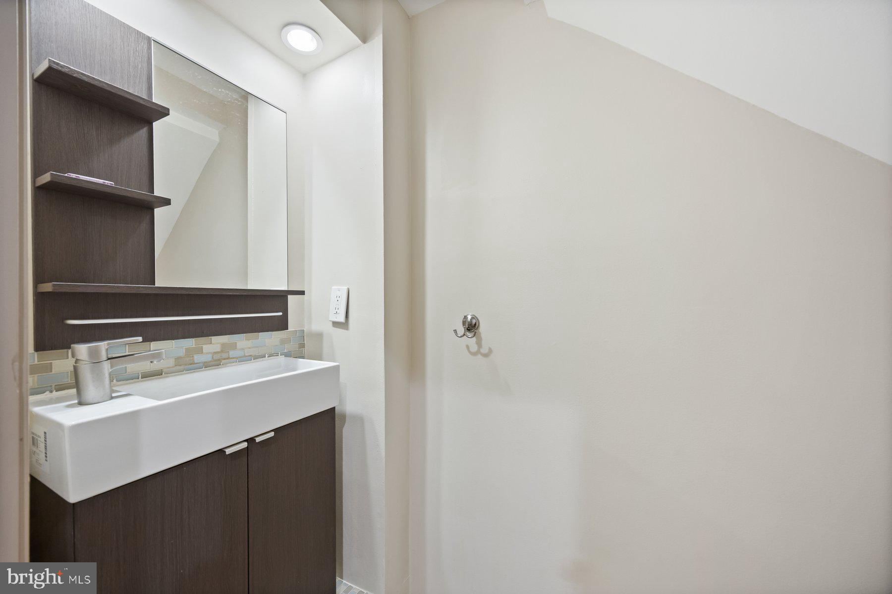 2209 Mullikin Street Baltimore, MD 21231 - Photo 22 of 32 a bathroom with a sink and a mirror