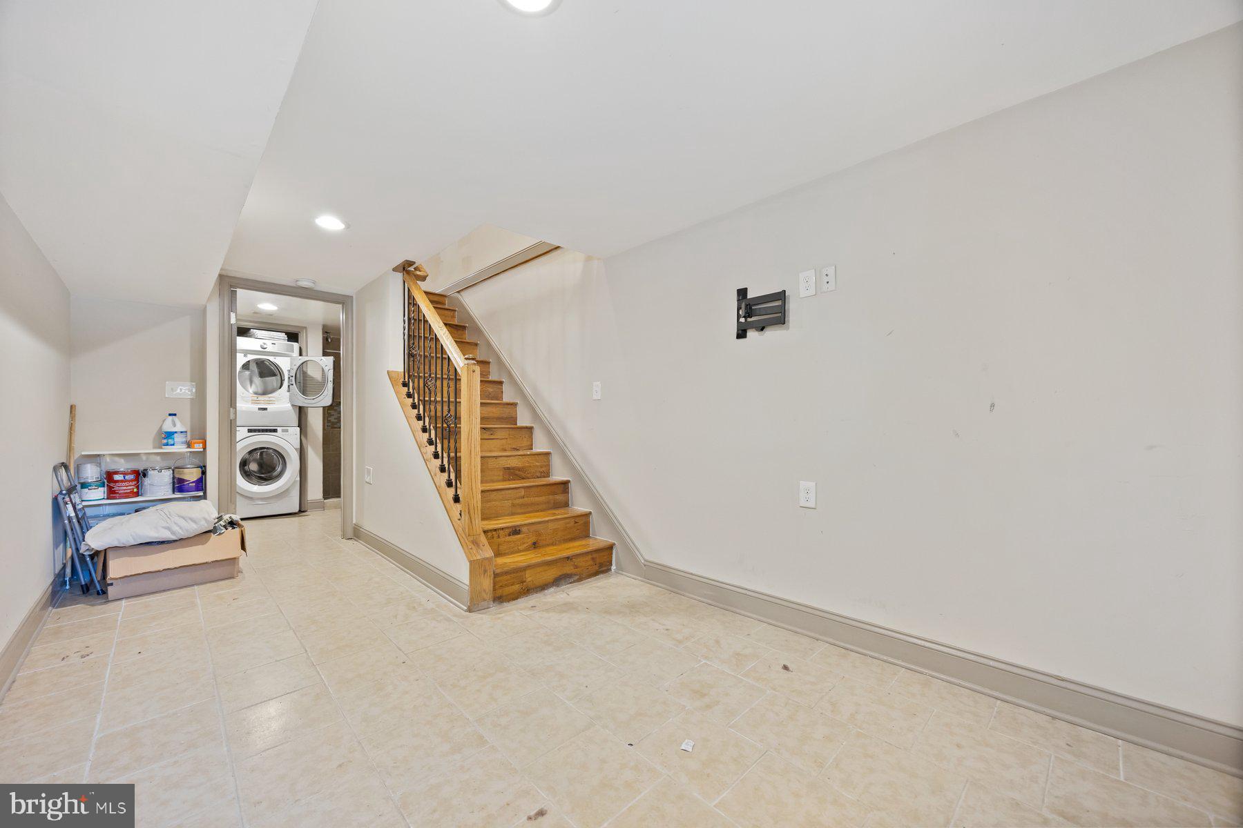 2209 Mullikin Street Baltimore, MD 21231 - Photo 24 of 32 a view of an empty room with stairs and a couch