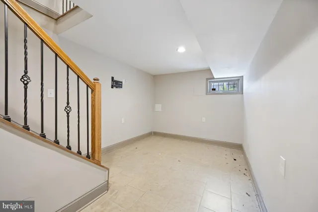 a view of a balcony with wooden floor and iron fence