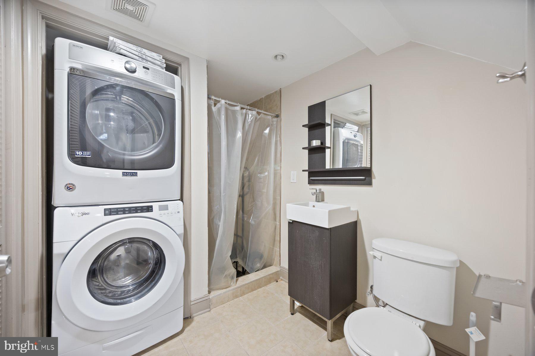 2209 Mullikin Street Baltimore, MD 21231 - Photo 26 of 32 a white toilet sitting next to a bathroom sink