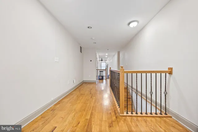 a view of a room with wooden floor