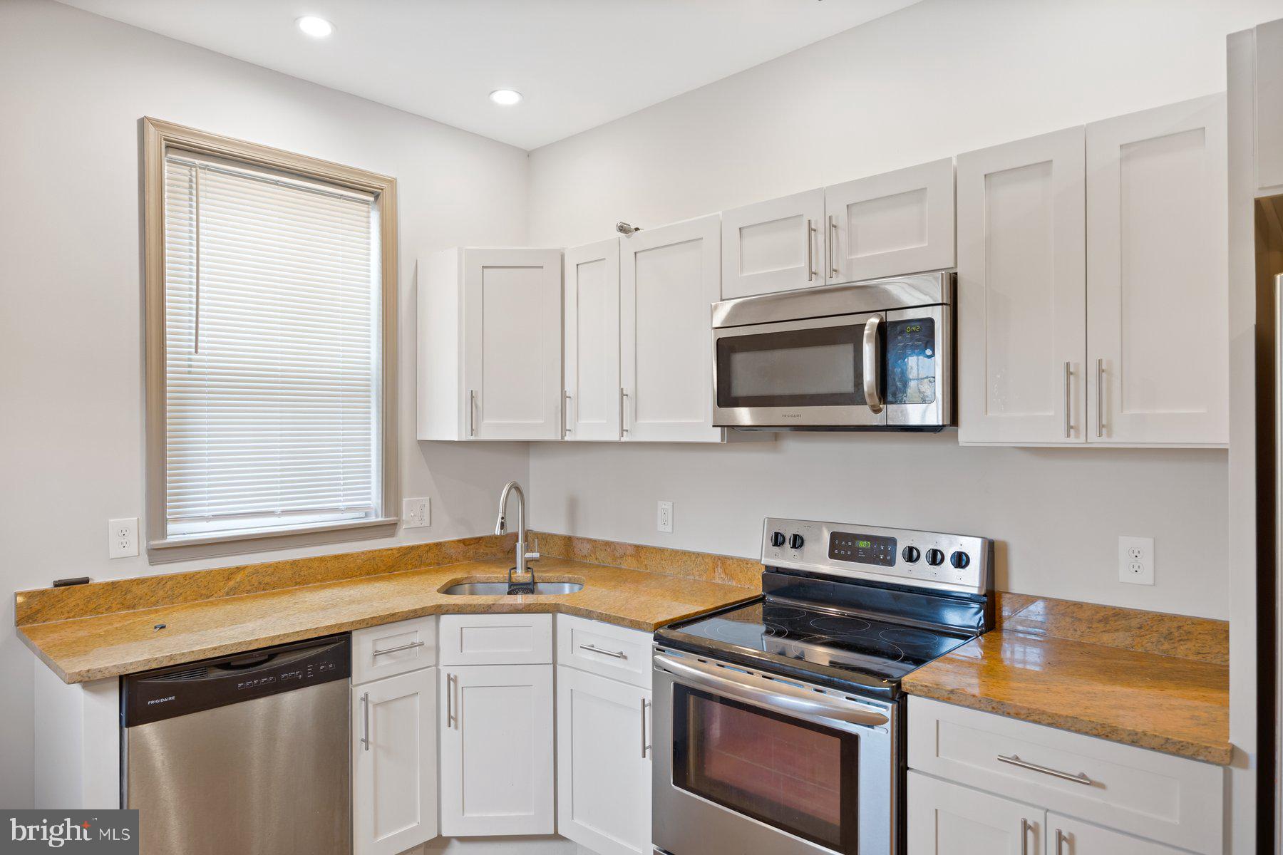 2209 Mullikin Street Baltimore, MD 21231 - Photo 9 of 32 a kitchen with a sink stove and microwave