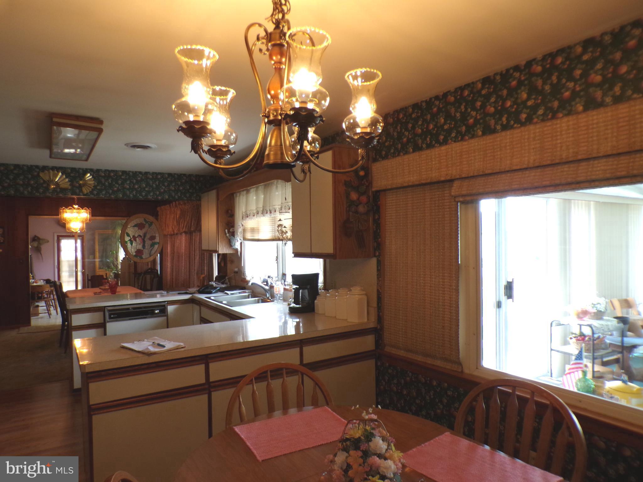 2713 Rowe Road New Windsor, MD 21776 - Photo 15 of 67 a kitchen with a sink and chandelier