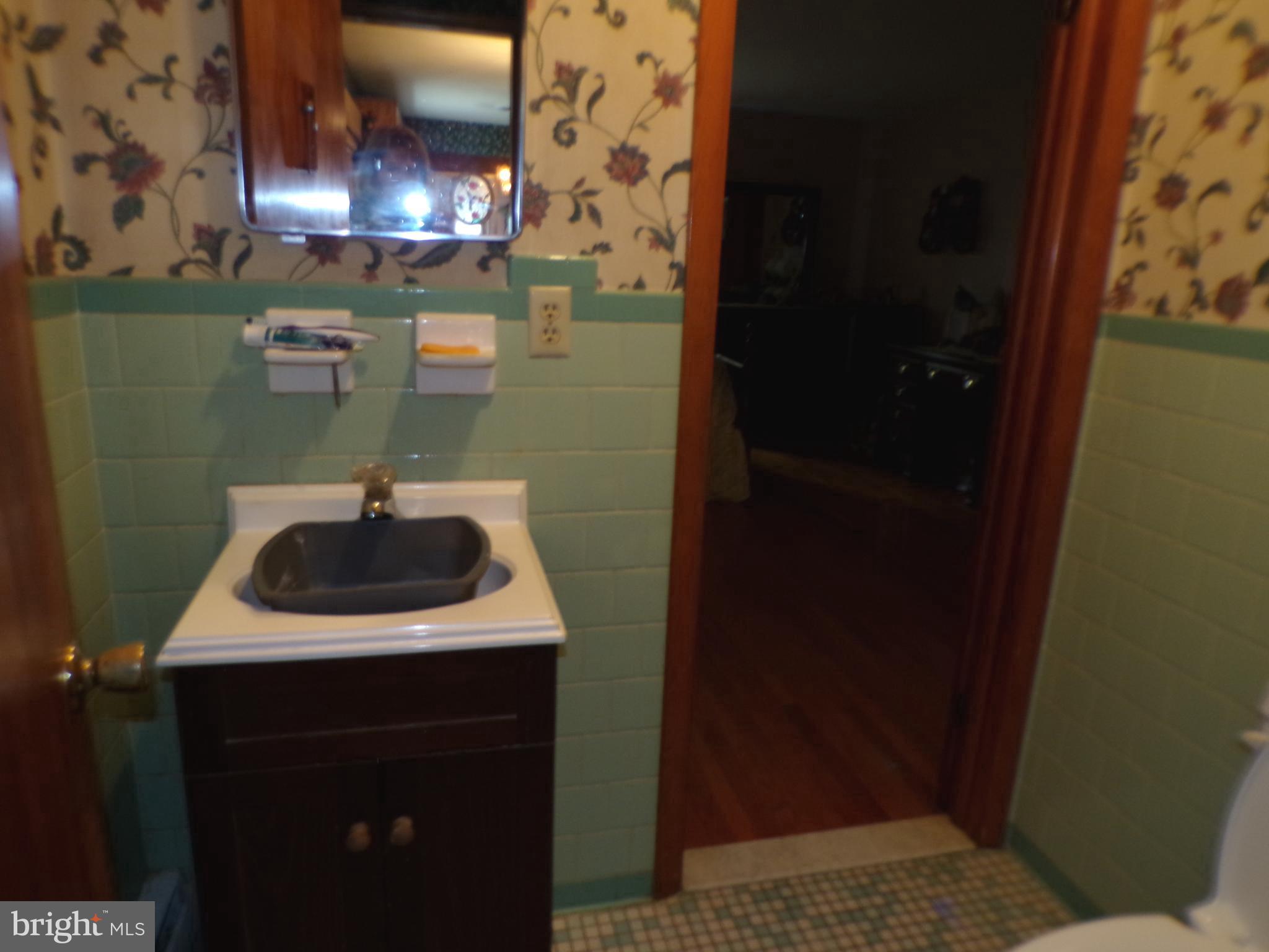 2713 Rowe Road New Windsor, MD 21776 - Photo 16 of 67 a bathroom with a sink and a mirror