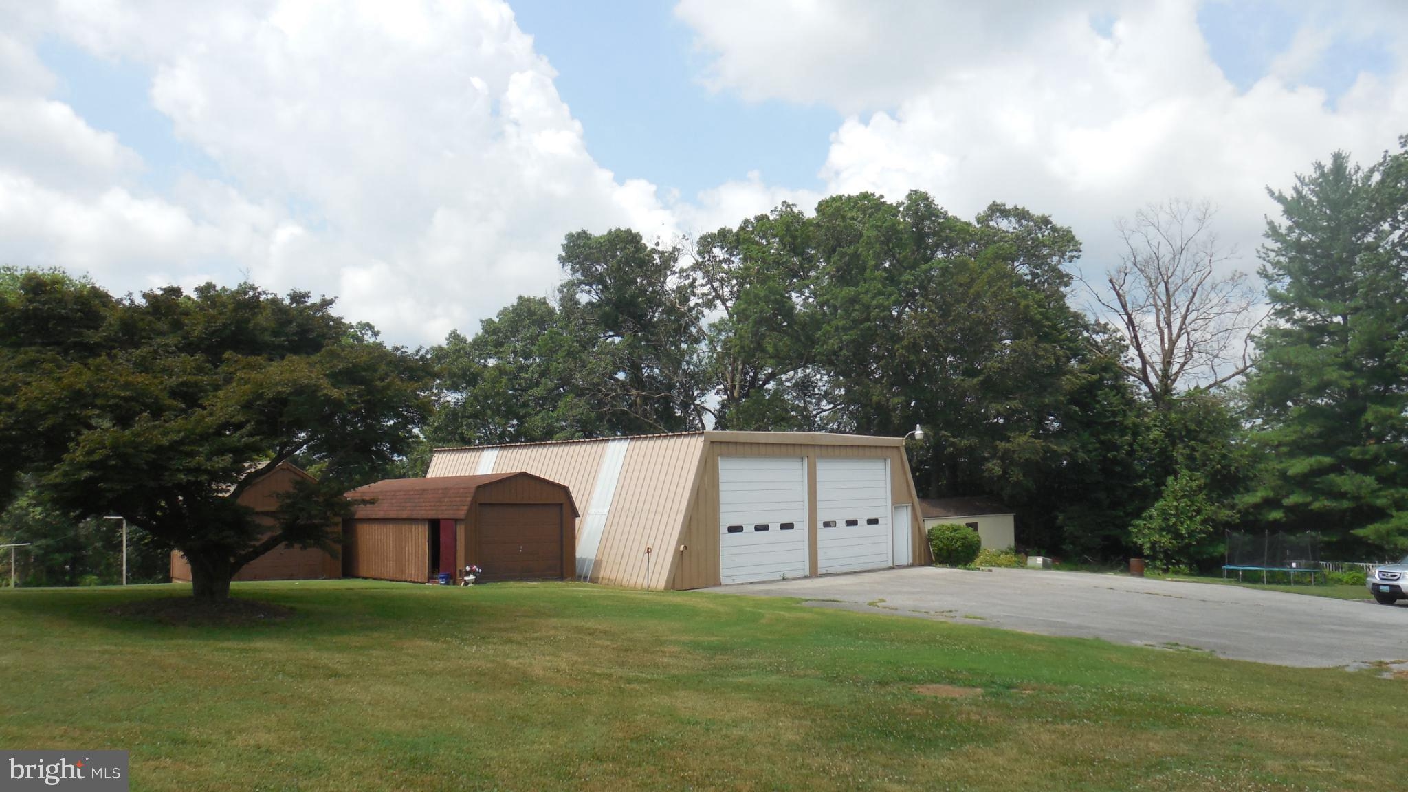 2713 Rowe Road New Windsor, MD 21776 - Photo 43 of 67 a large house with a big yard and large trees