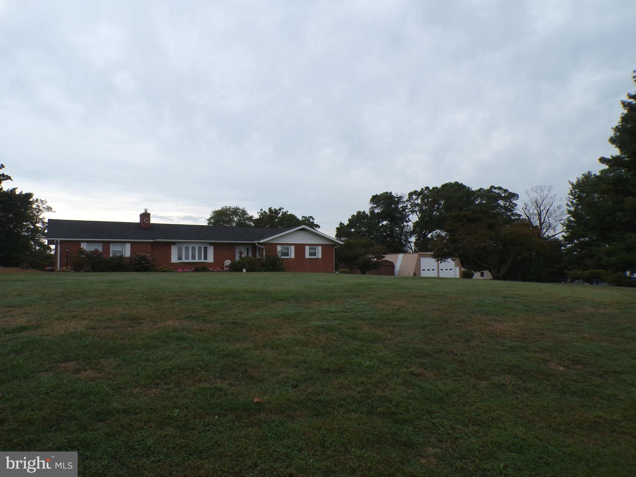 2713 Rowe Road New Windsor, MD 21776 - Photo 57 of 67 a view of a big house with a big yard and large trees