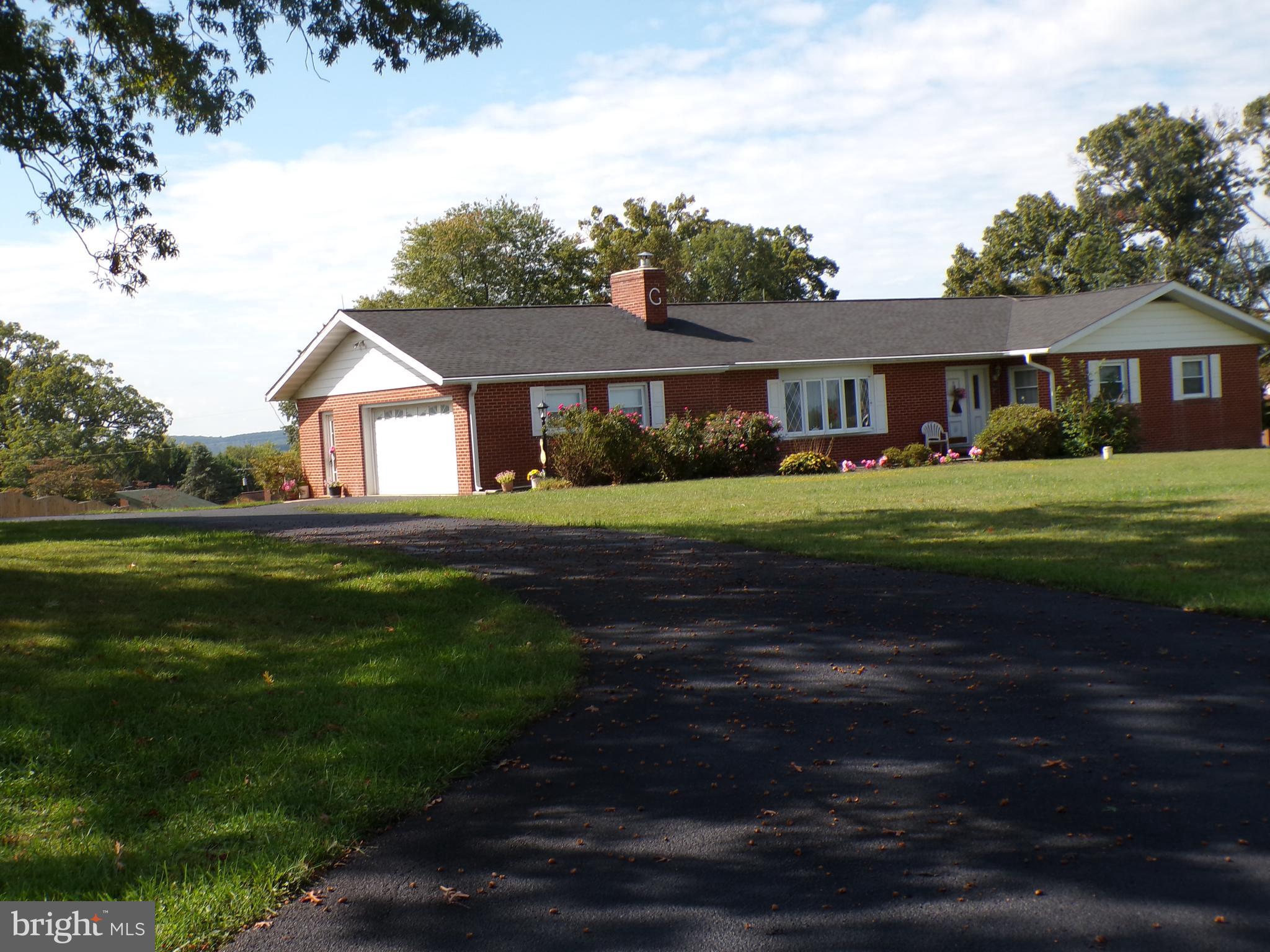 2713 Rowe Road New Windsor, MD 21776 - Photo 63 of 67 a front view of a house with a garden