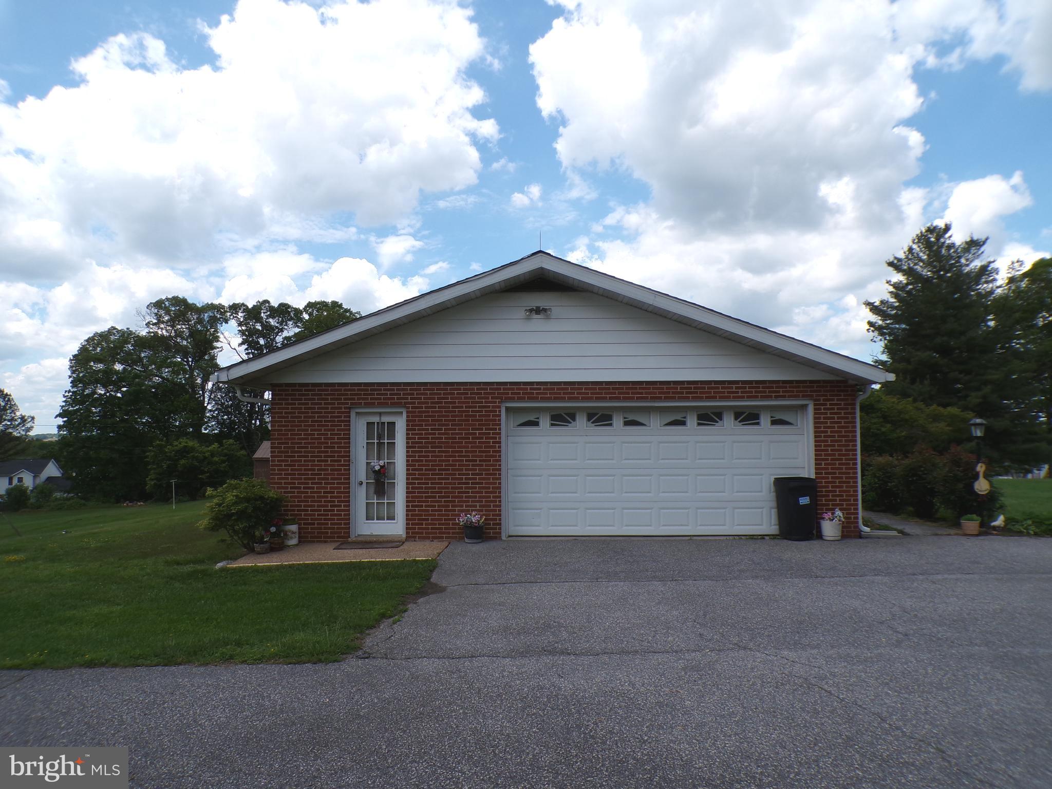 2713 Rowe Road New Windsor, MD 21776 - Photo 8 of 67 a front view of a house with a yard and garage