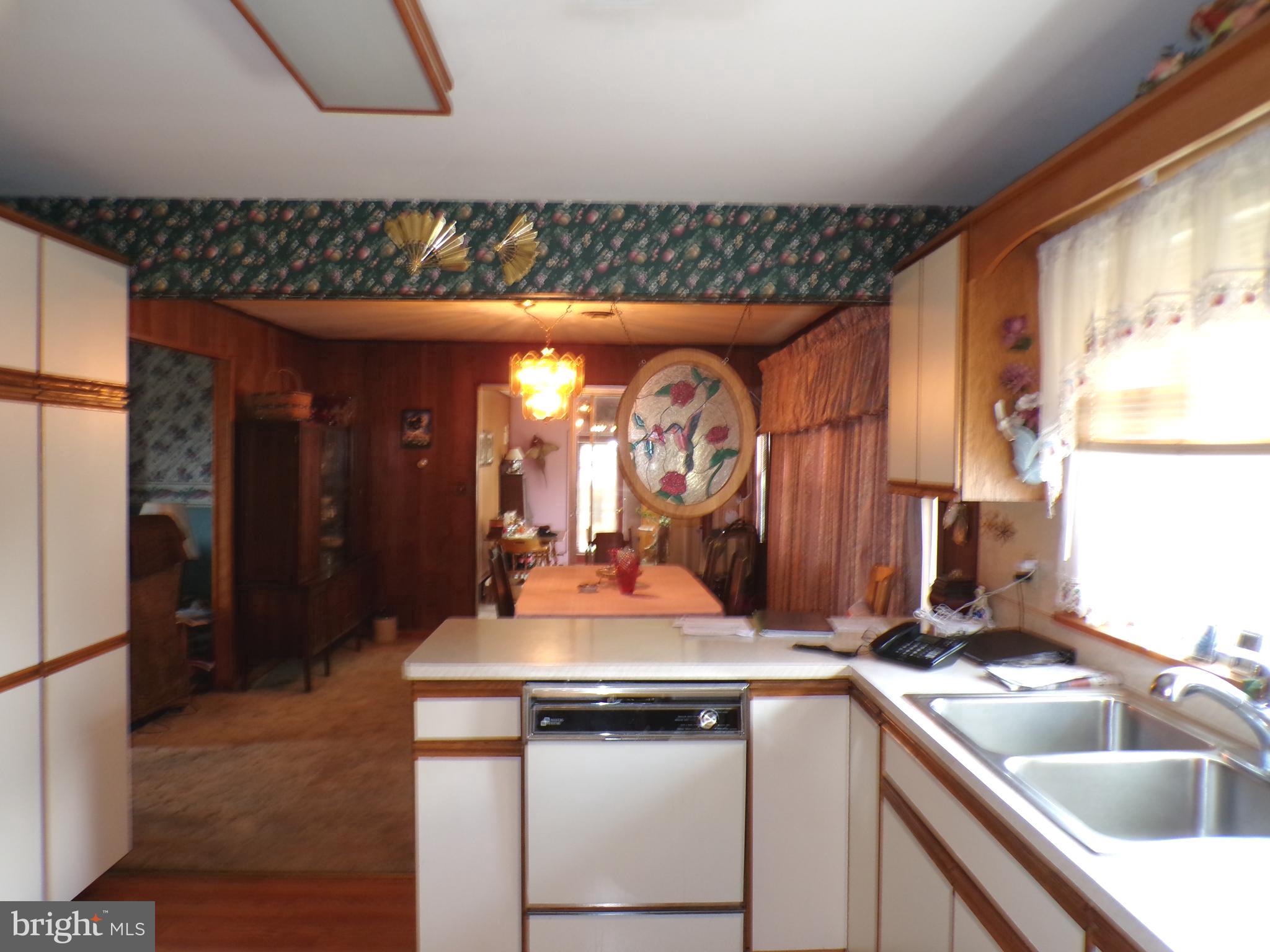 2713 Rowe Road New Windsor, MD 21776 - Photo 10 of 67 a kitchen with a sink and a refrigerator