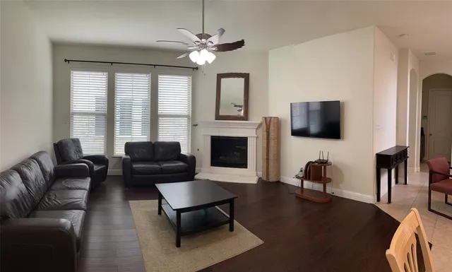 a large kitchen with a table and stainless steel appliances