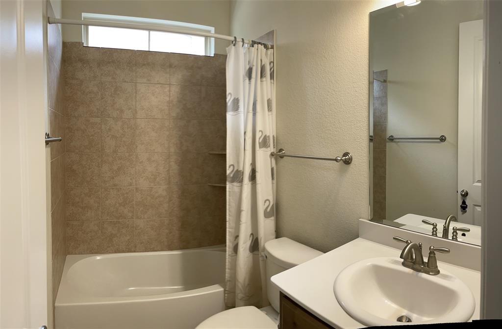 8031 Sunflower Lane Dallas, TX 75252 - Photo 18 of 34 a bathroom with a sink a toilet and shower