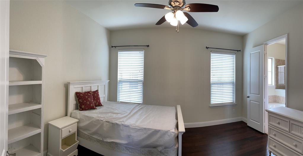 8031 Sunflower Lane Dallas, TX 75252 - Photo 19 of 34 a bedroom with a bed and a window