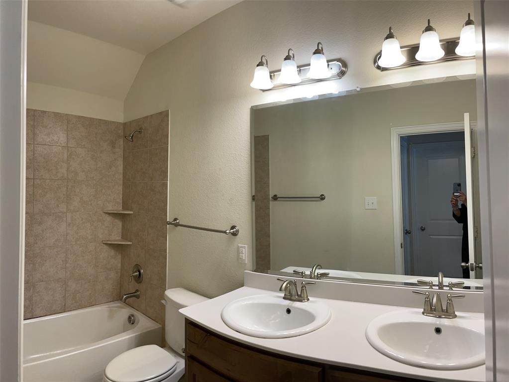 8031 Sunflower Lane Dallas, TX 75252 - Photo 22 of 34 a bathroom with a sink and a mirror