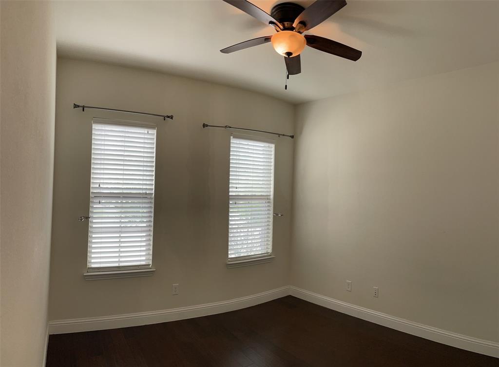 8031 Sunflower Lane Dallas, TX 75252 - Photo 28 of 34 an empty room with a window and a ceiling fan