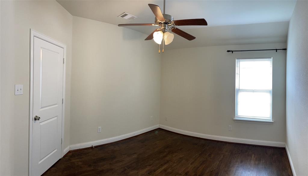 8031 Sunflower Lane Dallas, TX 75252 - Photo 29 of 34 an empty room with wooden floor fan and windows