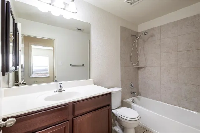 a view of a room with wooden floor and a window