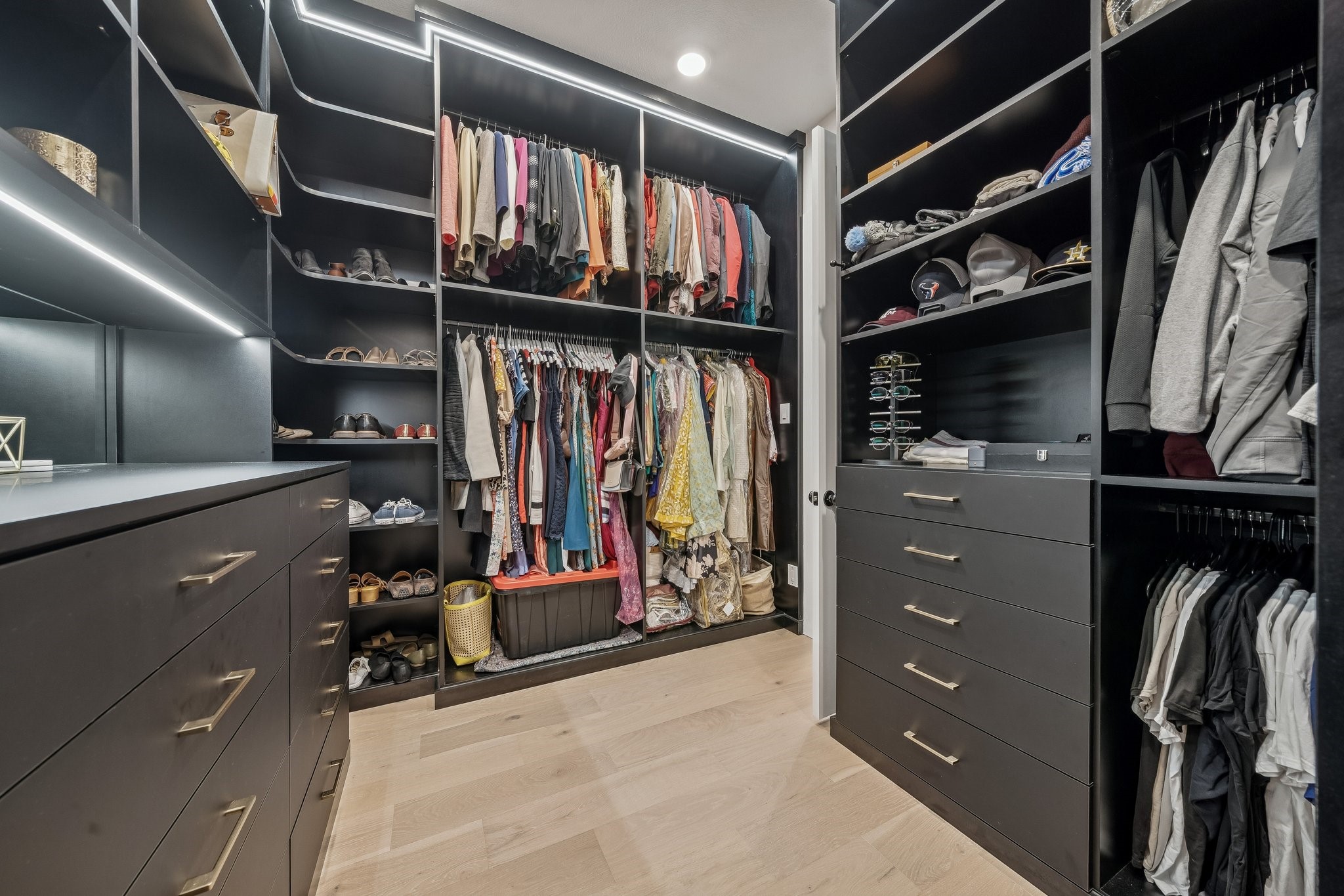 8703 Blue Grotto Lane Manvel, TX 77578 - Photo 18 of 43 The primary closet with custom cabinetry and lighting.