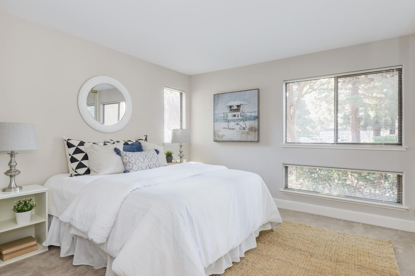 928 Wright Avenue, Unit 401 Mountain View, CA 94043 - Photo 14 of 18 a bedroom with a bed and a window