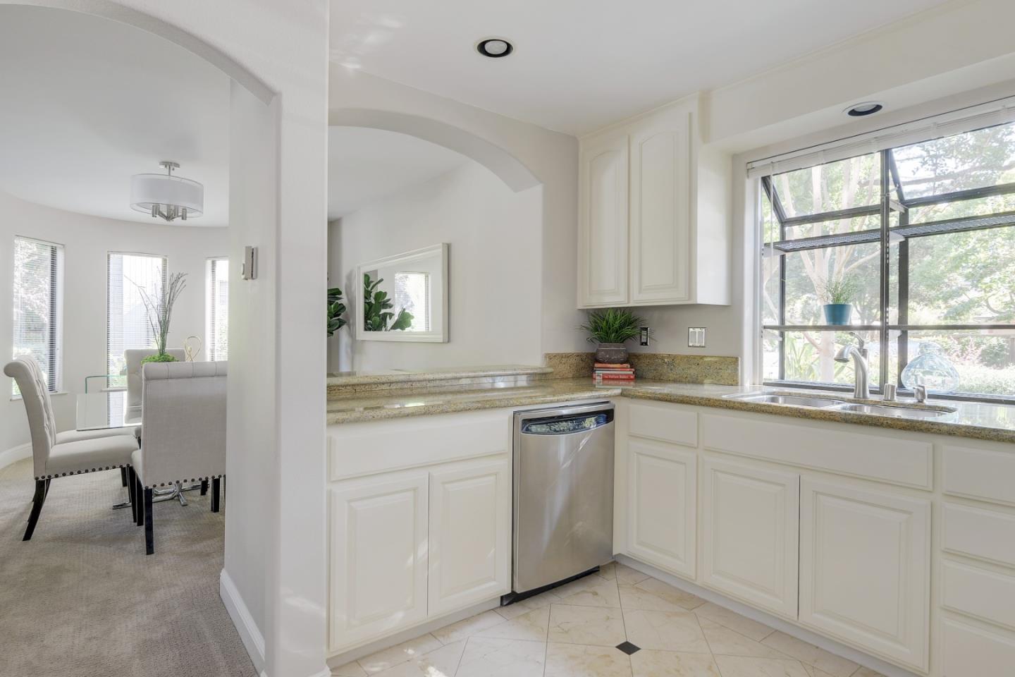 928 Wright Avenue, Unit 401 Mountain View, CA 94043 - Photo 4 of 18 a kitchen with white cabinets and sink