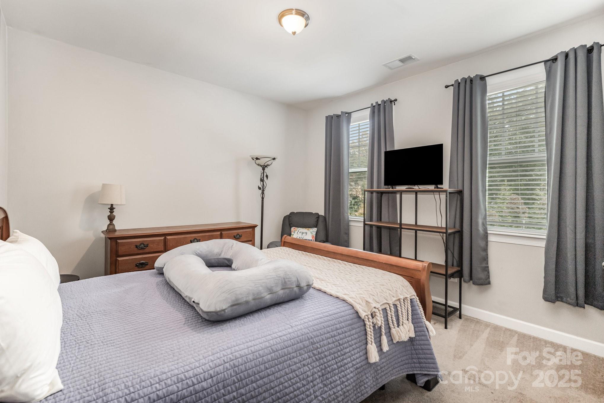 1556 Prickly Lane Waxhaw, NC 28173 - Photo 14 of 39 a bedroom with a bed and a flat screen tv