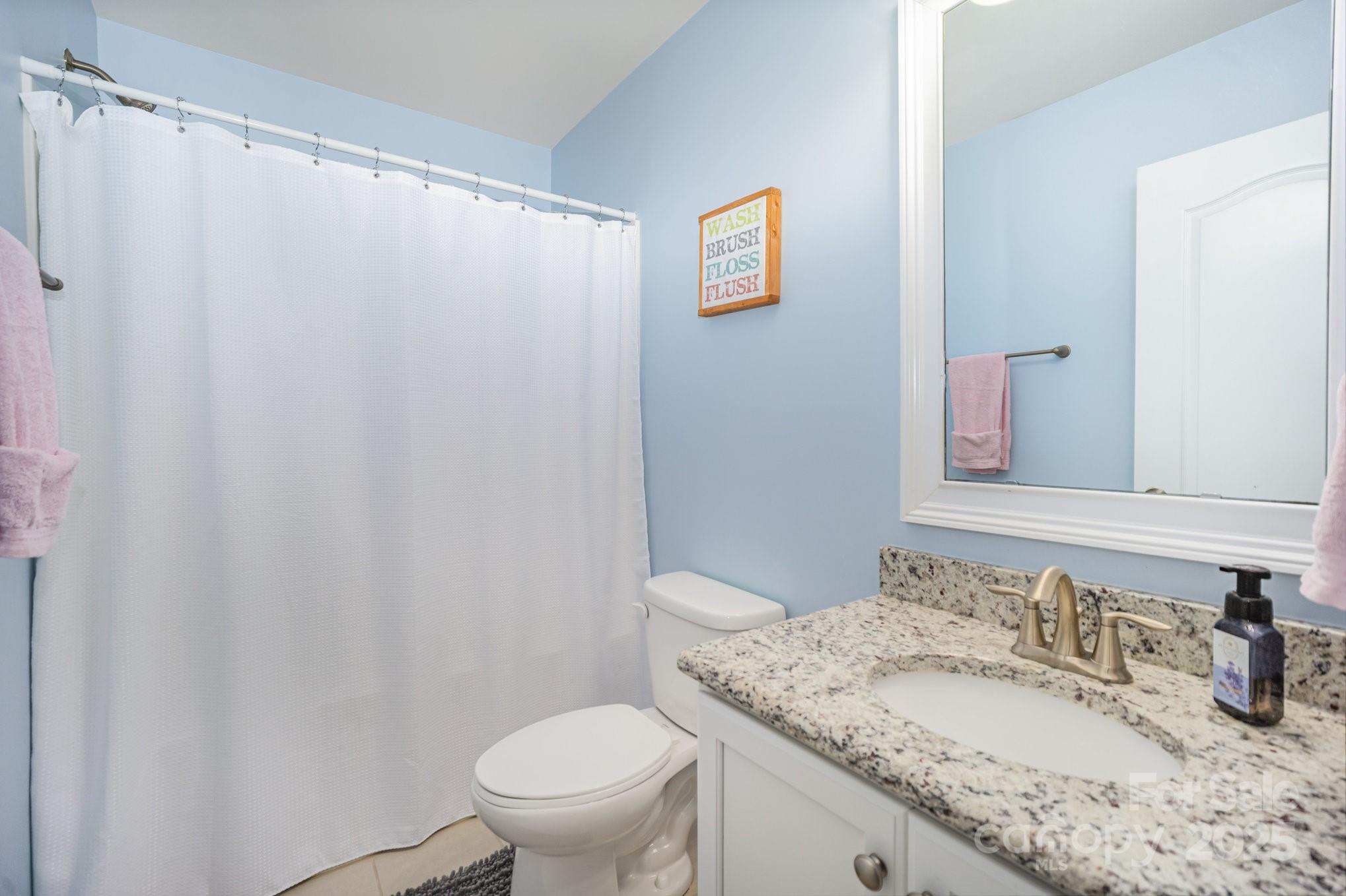 1556 Prickly Lane Waxhaw, NC 28173 - Photo 15 of 39 a bathroom with a granite countertop sink and a mirror