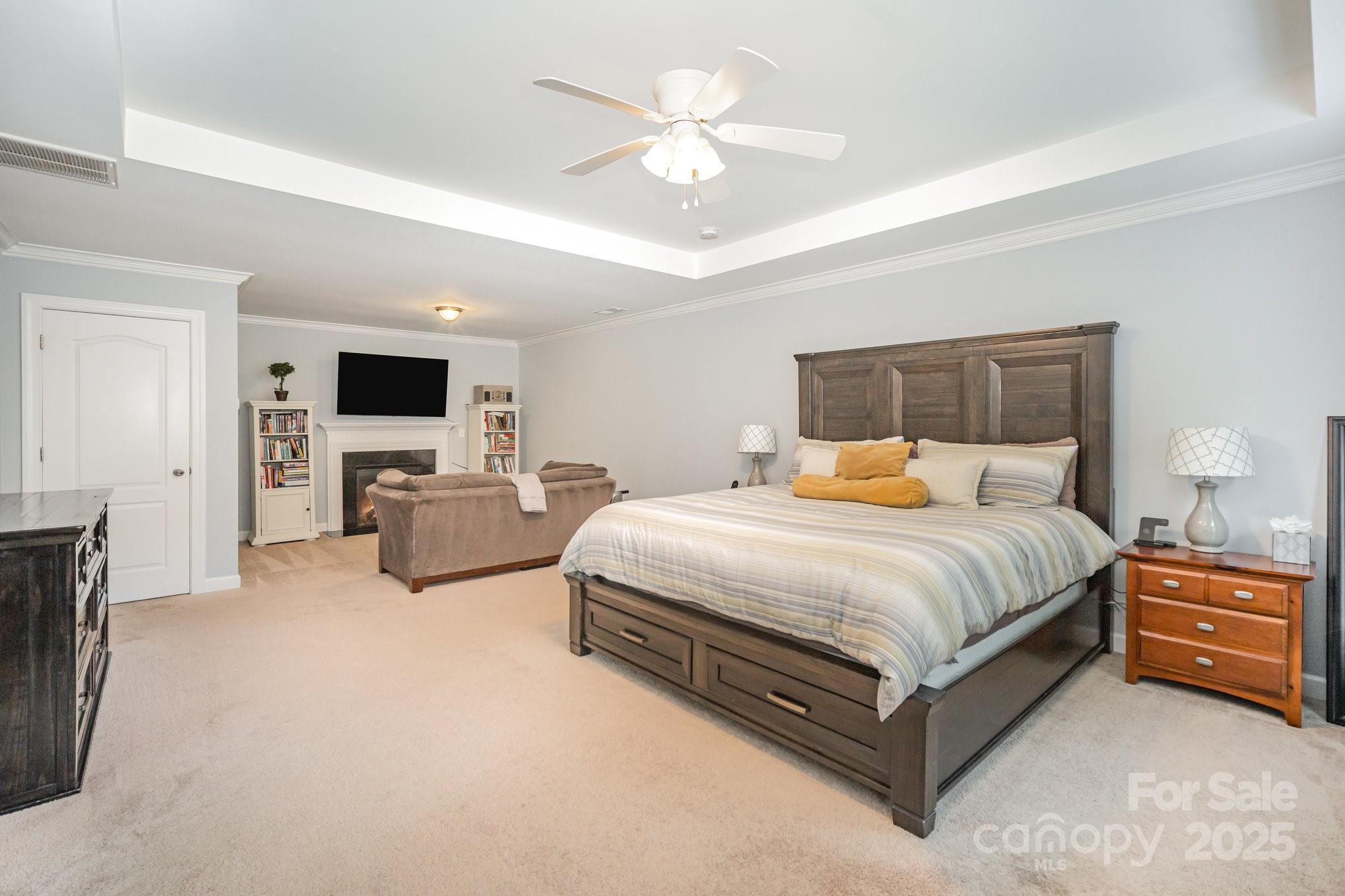 1556 Prickly Lane Waxhaw, NC 28173 - Photo 18 of 39 a spacious bedroom with a bed and a chandelier