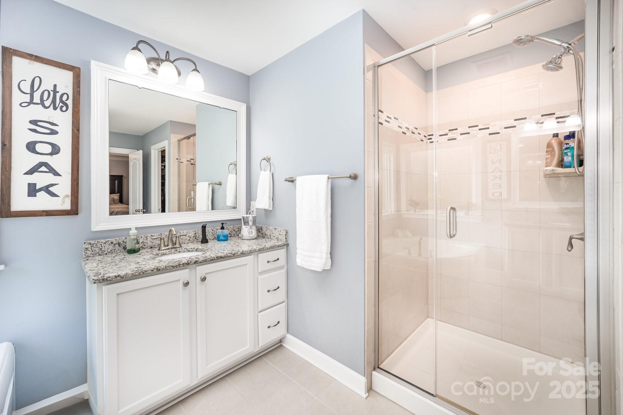1556 Prickly Lane Waxhaw, NC 28173 - Photo 21 of 39 a bathroom with a granite countertop shower sink vanity and mirror