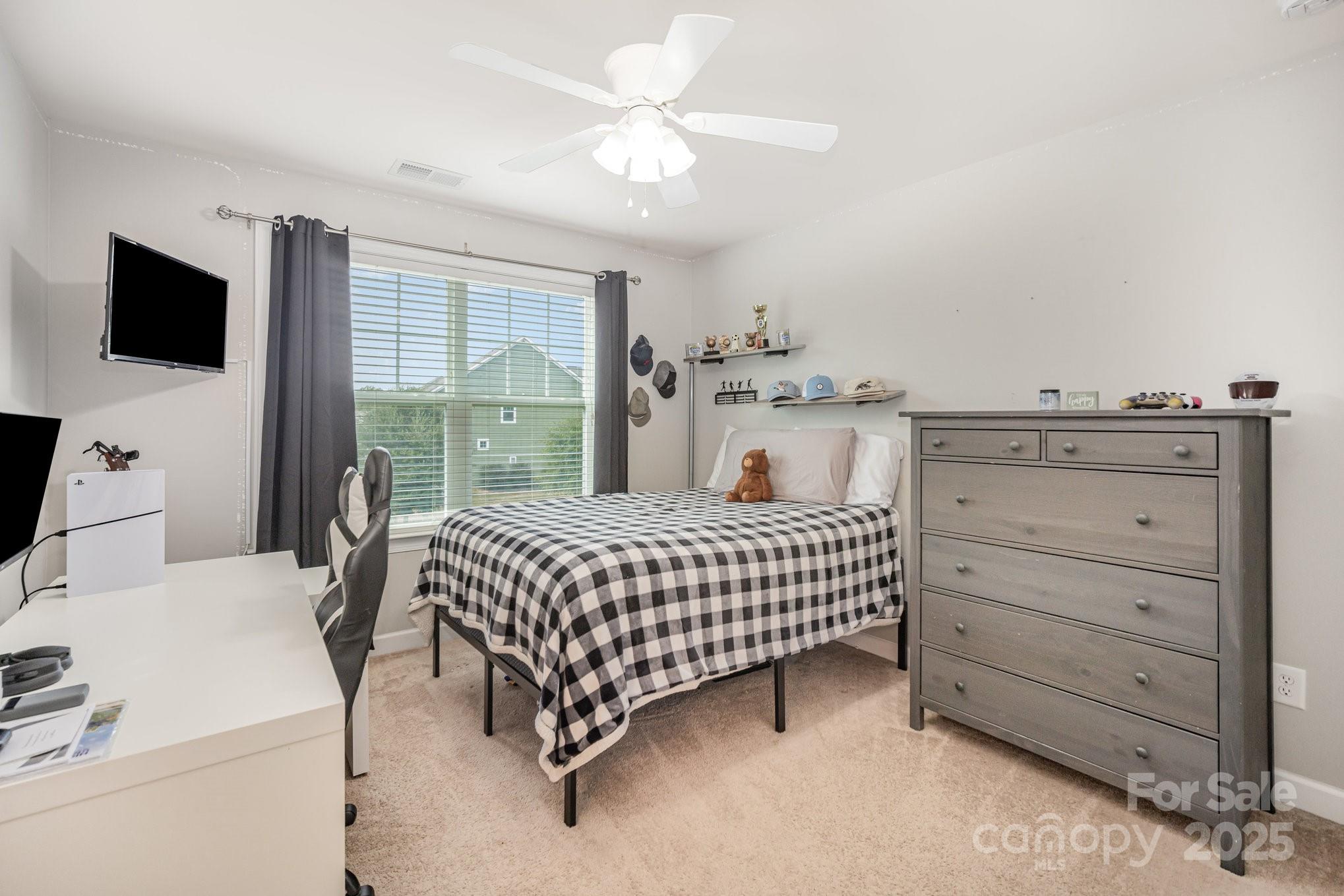 1556 Prickly Lane Waxhaw, NC 28173 - Photo 22 of 39 a bedroom with a bed and a flat tv screen on dresser
