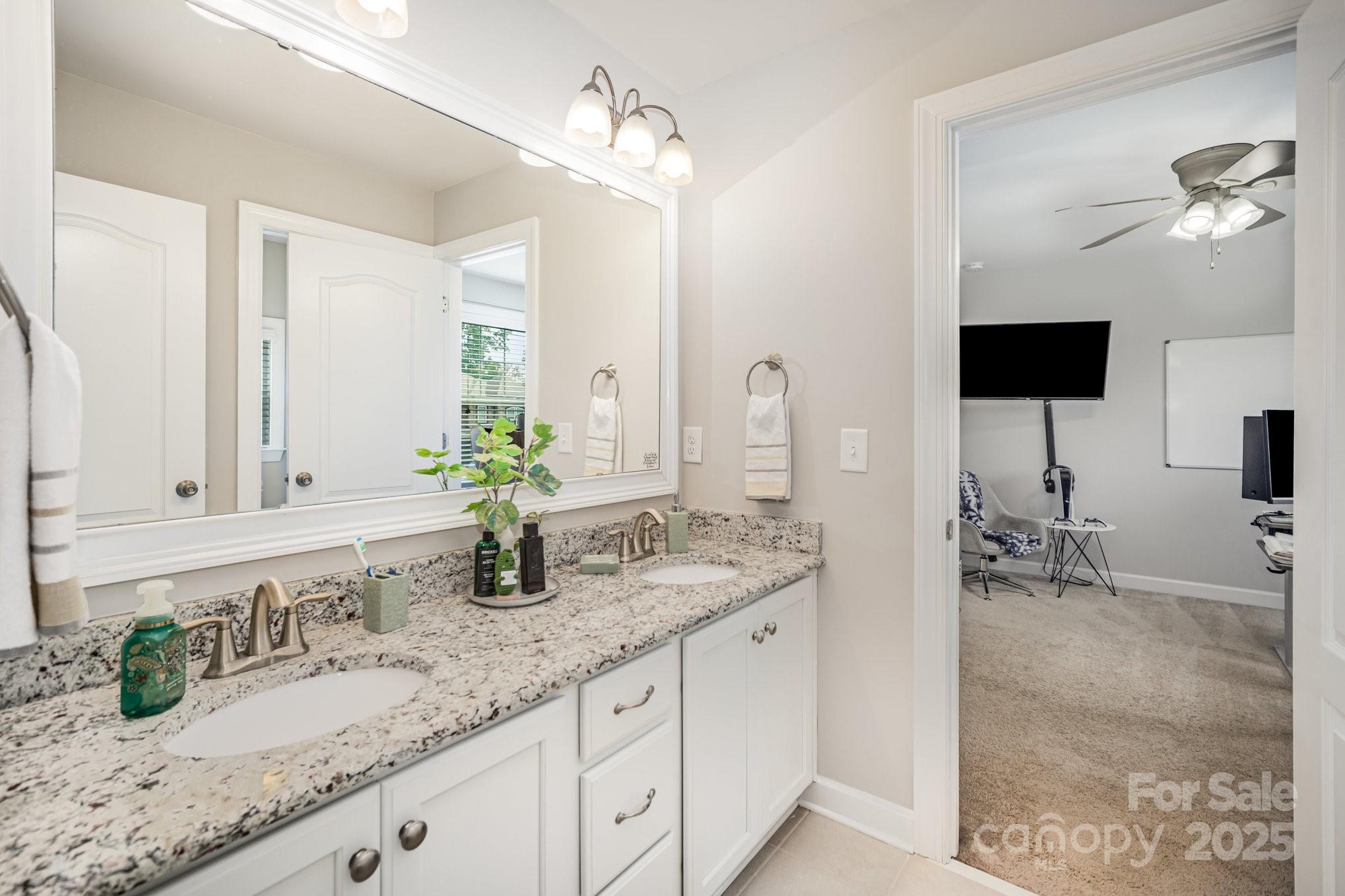 1556 Prickly Lane Waxhaw, NC 28173 - Photo 23 of 39 a bathroom with sink and mirror