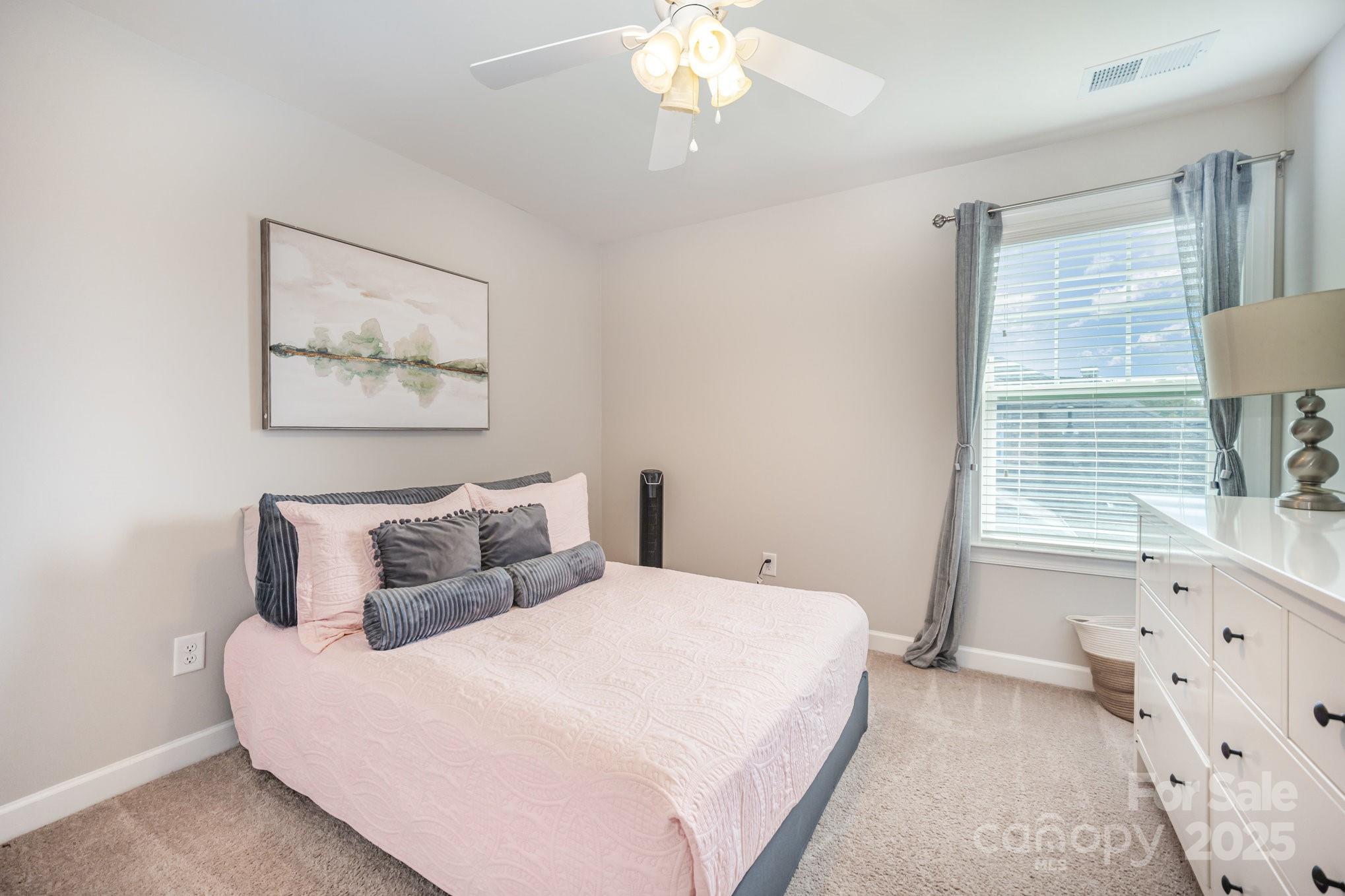 1556 Prickly Lane Waxhaw, NC 28173 - Photo 25 of 39 a bedroom with a large bed and a window