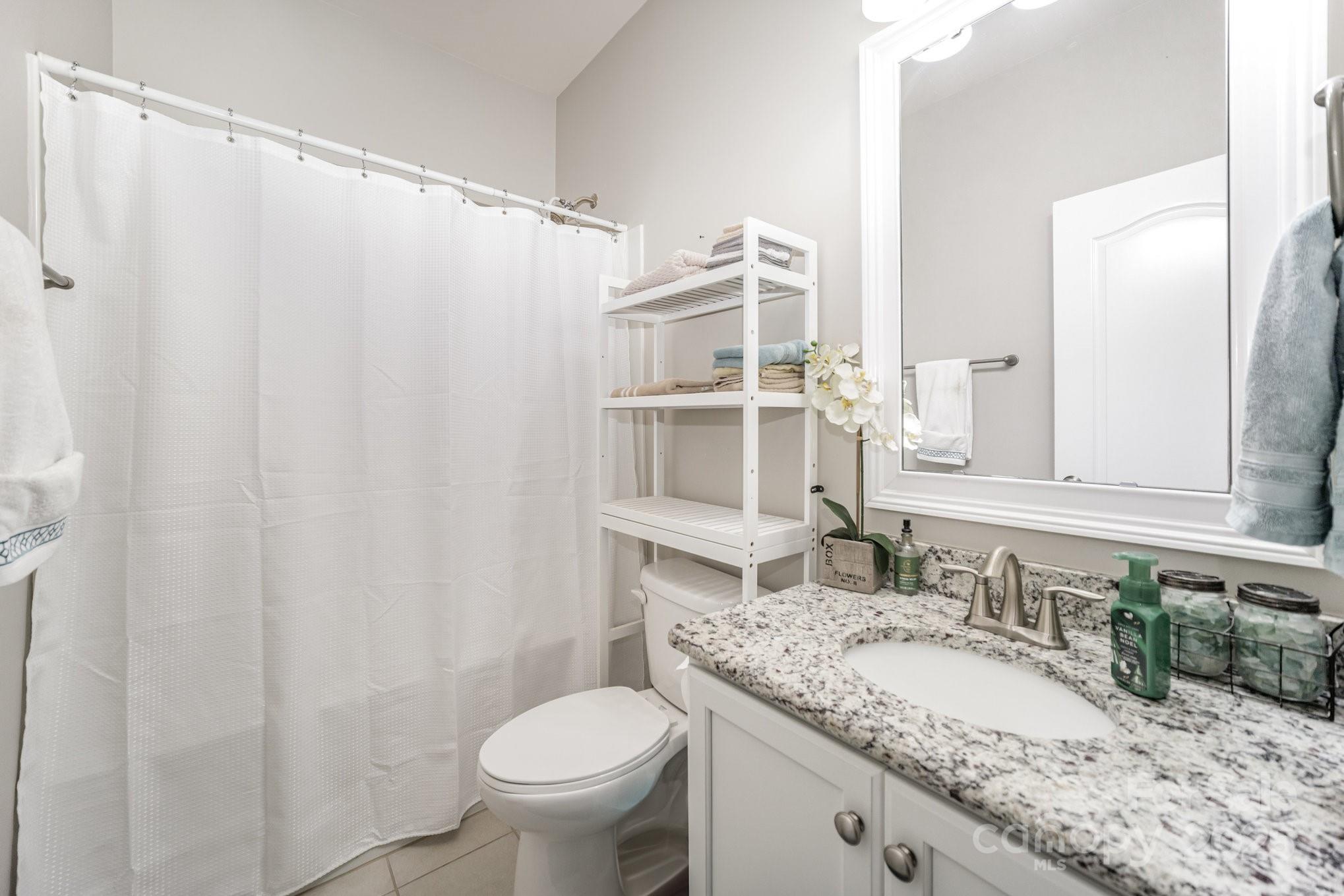1556 Prickly Lane Waxhaw, NC 28173 - Photo 26 of 39 a bathroom with a granite countertop sink and a mirror