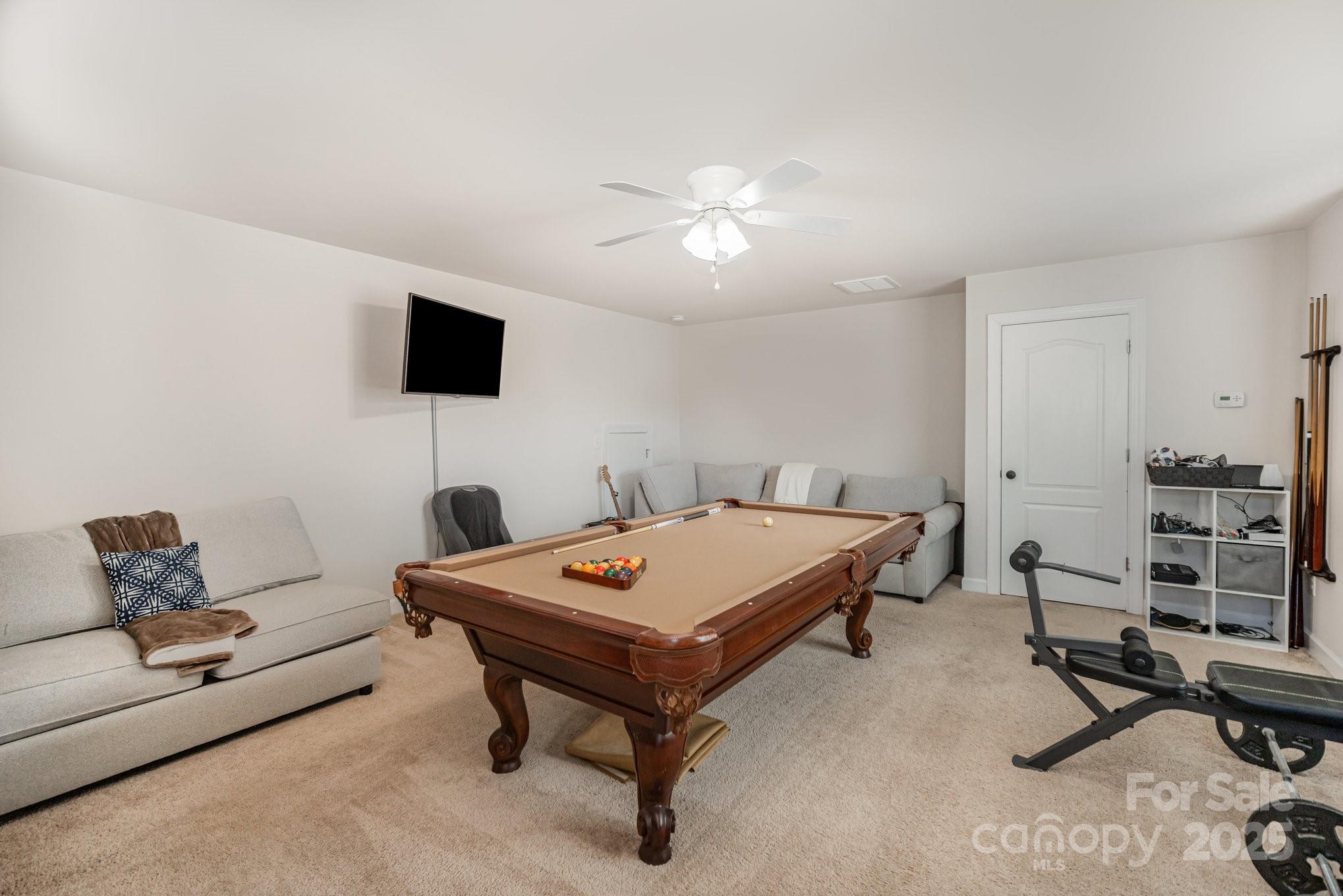 1556 Prickly Lane Waxhaw, NC 28173 - Photo 28 of 39 a living room with furniture and a flat screen tv