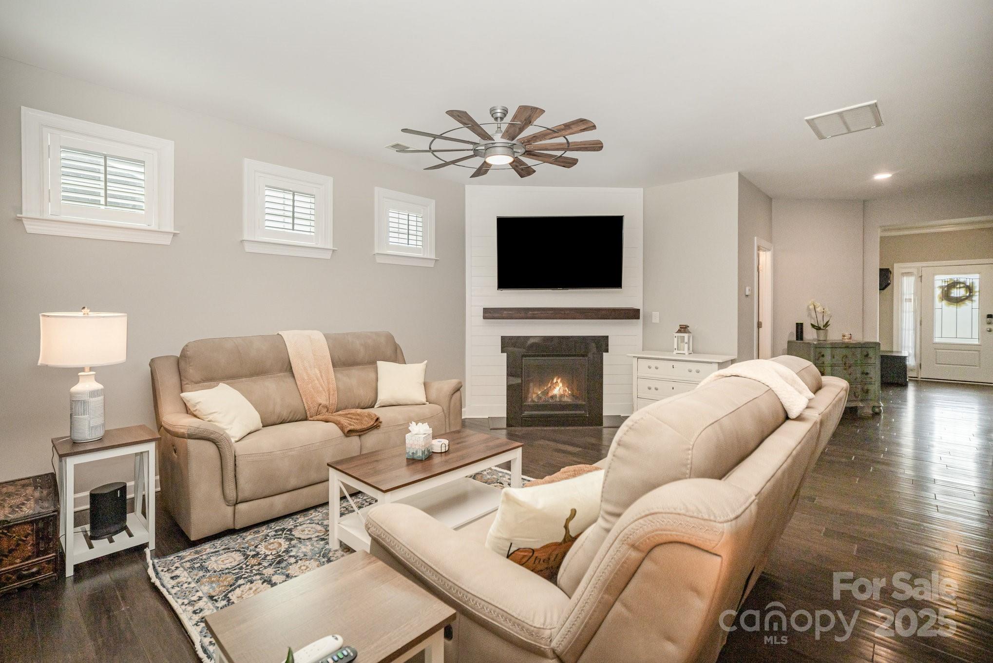1556 Prickly Lane Waxhaw, NC 28173 - Photo 7 of 39 a living room with furniture a fireplace and a flat screen tv
