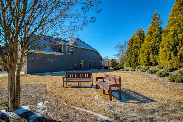 a open kitchen with stainless steel appliances granite countertop a stove top oven a sink dishwasher a dining table and chairs with wooden floor