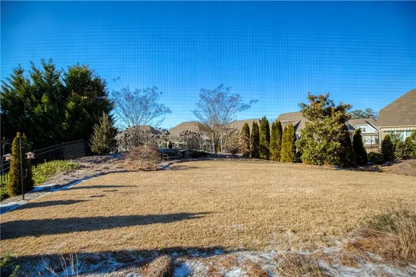 a backyard of a house with table and chairs