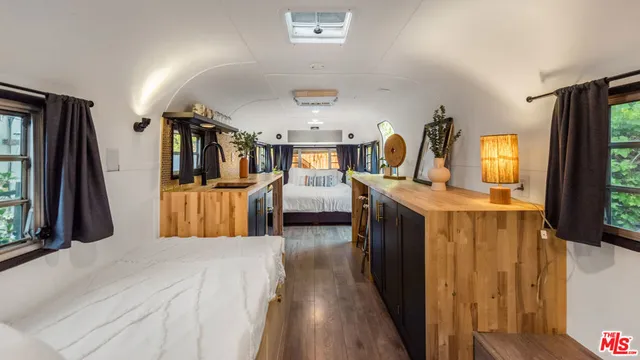 a view of a living room with furniture and flat screen tv