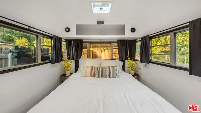 a large bedroom with a large bed and a large window